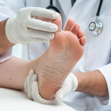 Podiatrist examining a patient's foot, showcasing expert foot care and treatment options at Opensky Podiatry.